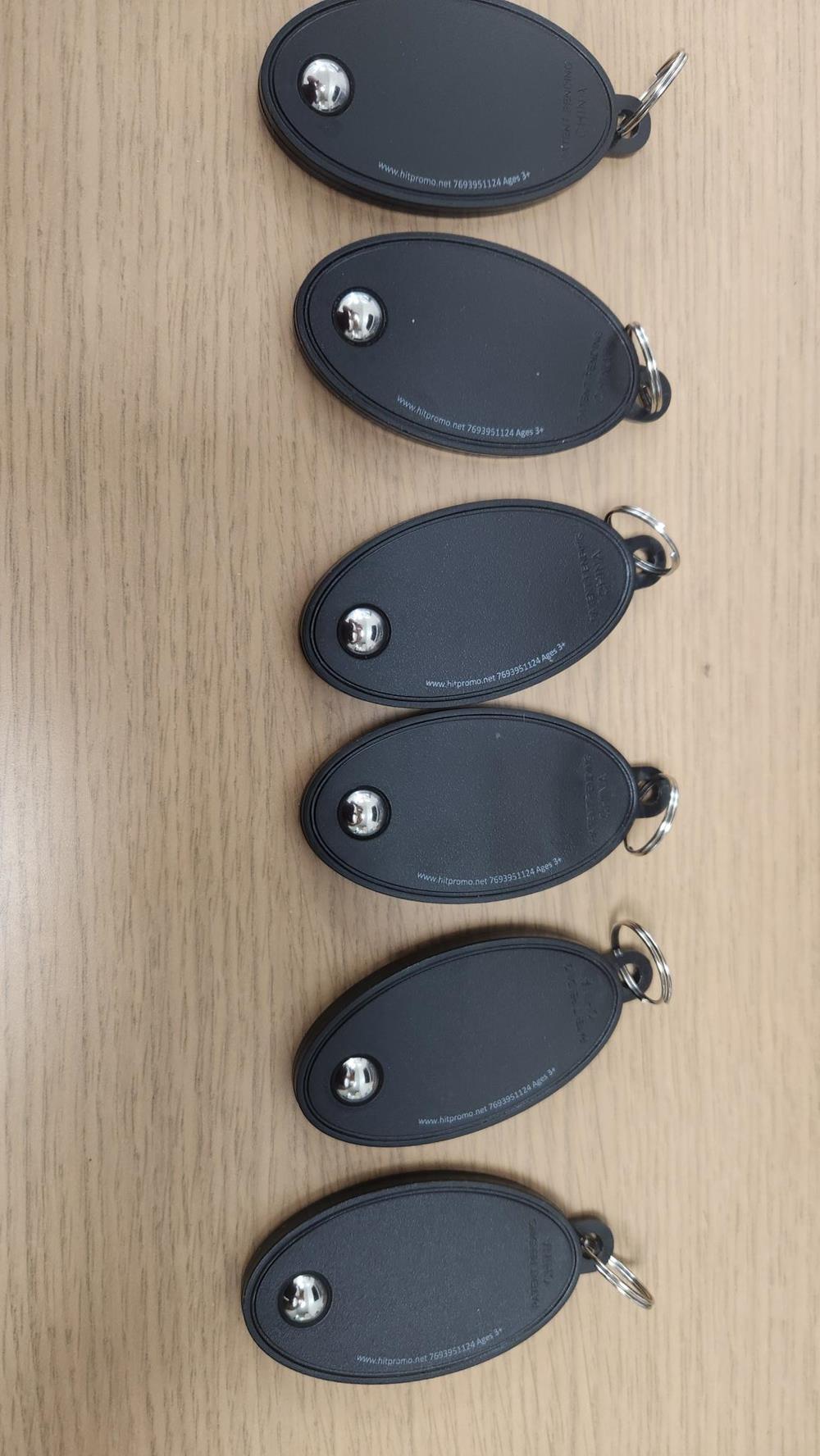 Customer photo from Eli of our Roller Ball Fidget Keychain - 24 hr, a group of black oval shaped keychains
