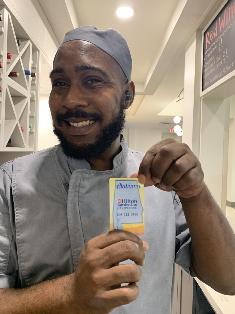 Customer photo from Aubrey of our Business Card Magnet - 20 mil - Round Corners, a man holding a card