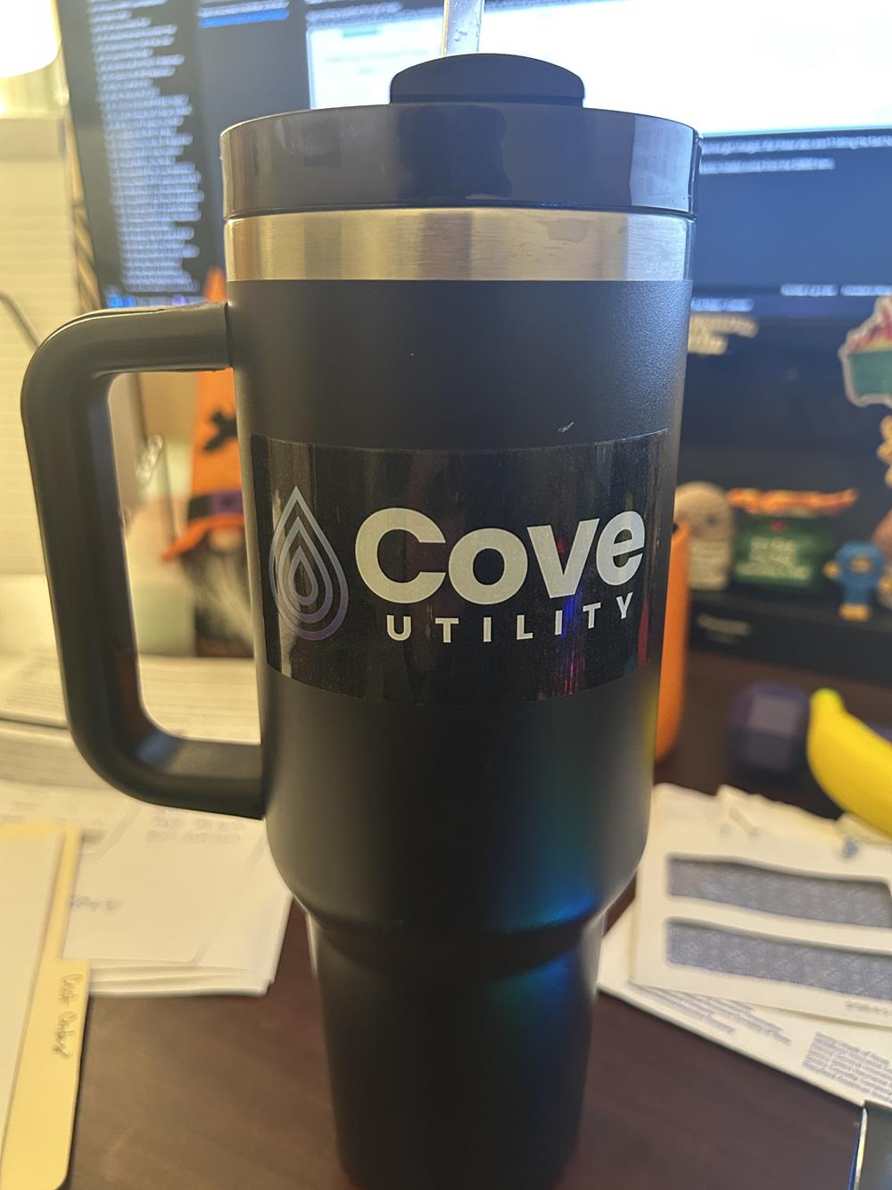 Customer photo from Jeff of our Full Color Sticker - Rectangle - 2" x 4", a black and silver coffee mug
