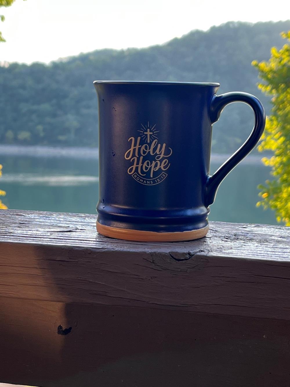 Customer photo from Sarah of our Allure Coffee Mug - 14 oz., a blue mug on a wood railing