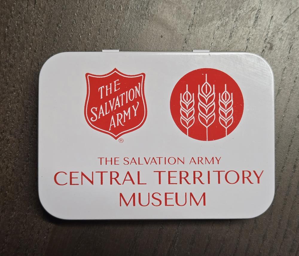 Customer photo from Nanci of our Metal Tin First Aid Kit - 24 hr, a white rectangular object with red text and symbols on it