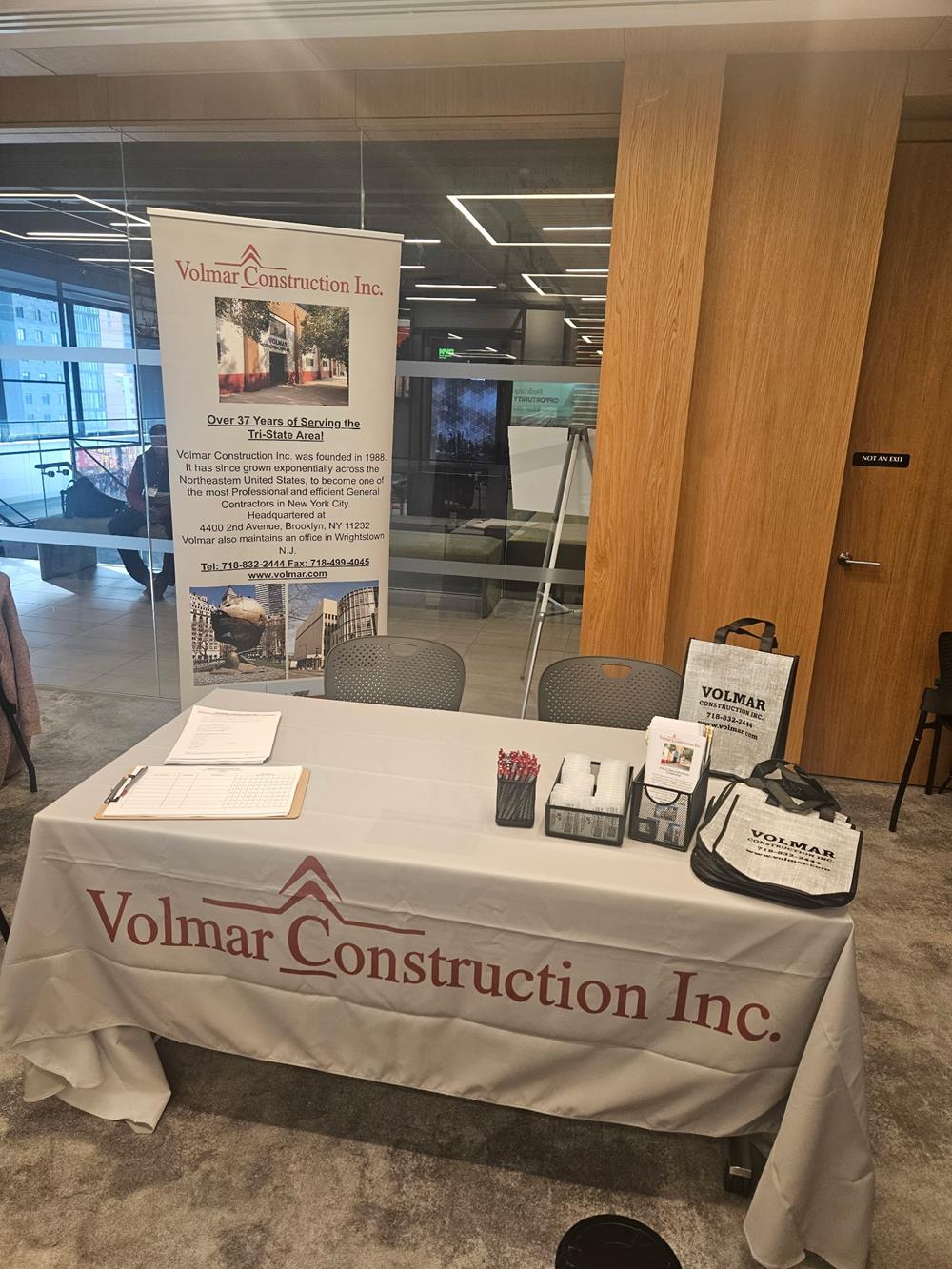 Customer photo from Vicky of our Ideal Retractable Banner Display - 33-1/2", a table with a white tablecloth and a sign