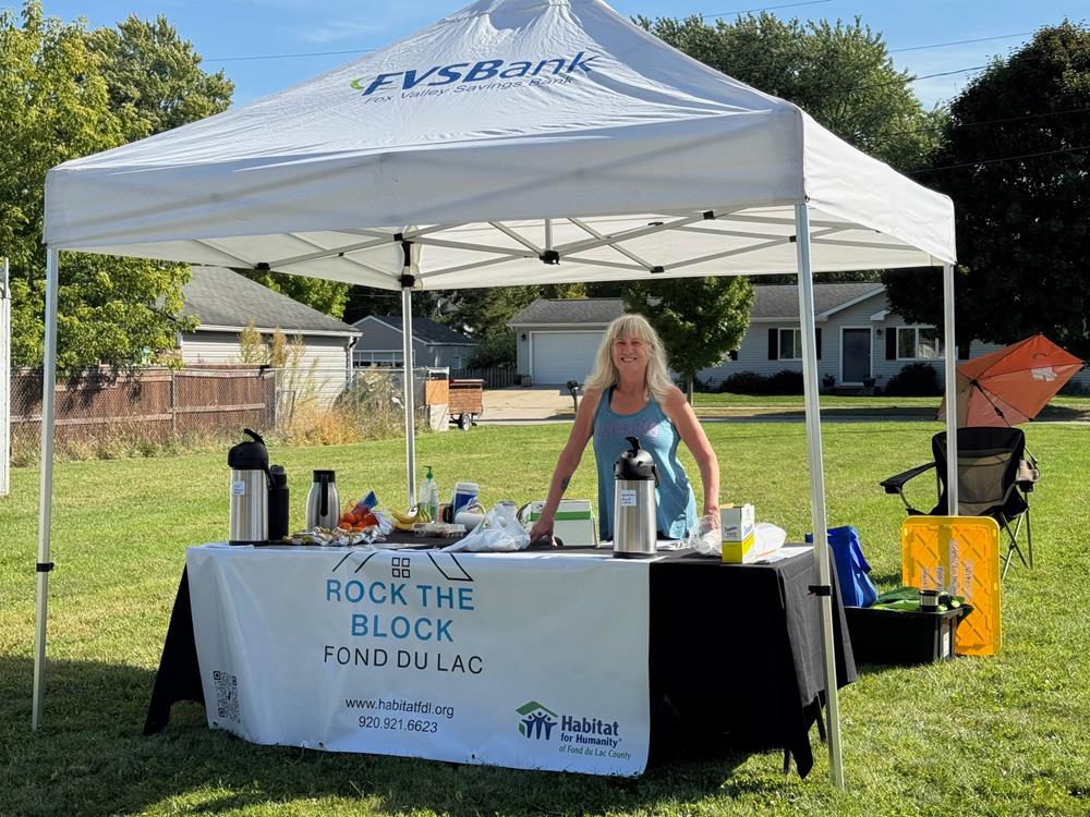 Customer photo from Kathy of our Value Indoor Banner - 3' x 6', a woman standing behind a tent