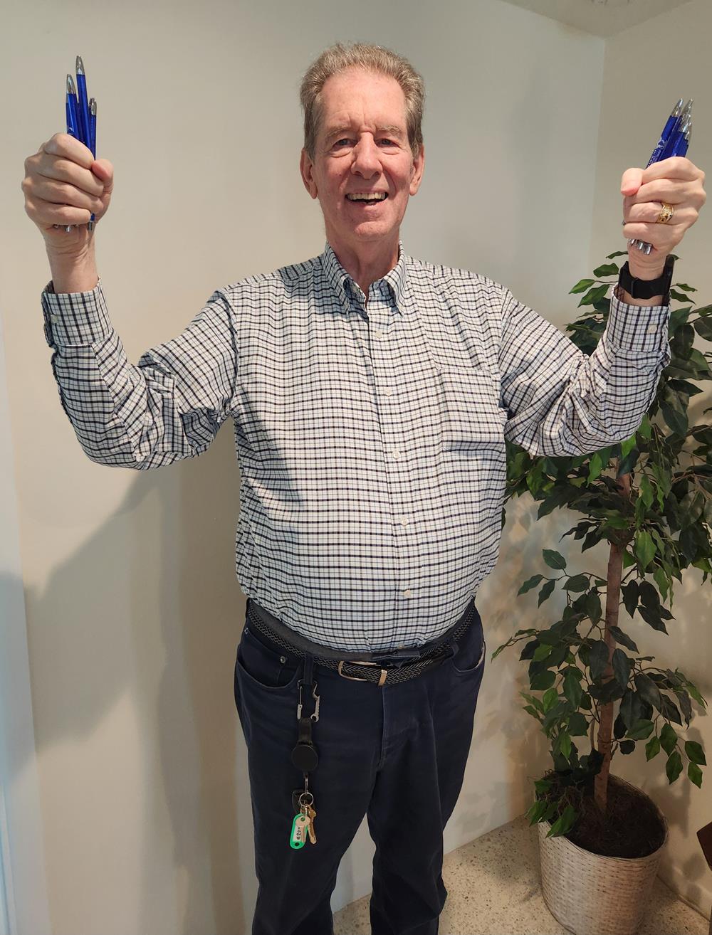 Customer photo from Karen of our Rack Cards - 9" x 4", a man holding up two blue guns