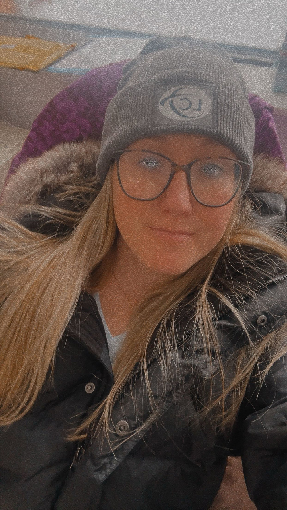 Customer photo from Gabrielle of our Grip-it Luggage Identifier, a woman wearing glasses and a hat