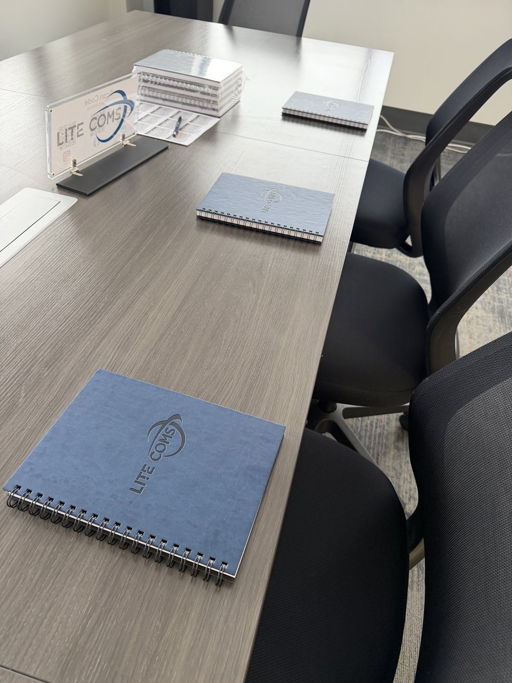 Customer photo from Gabrielle of our Grip-it Luggage Identifier, a table with notebooks on it