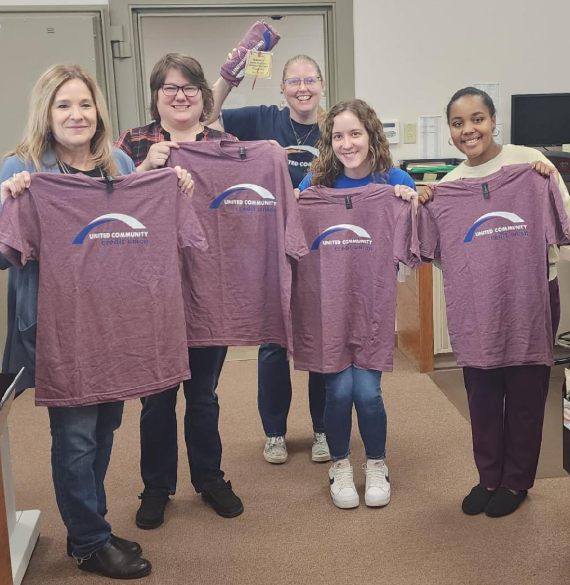 Customer photo from Kristie of our Gildan Softstyle T-Shirt - Men's - Colors - Screen, a group of people holding shirts