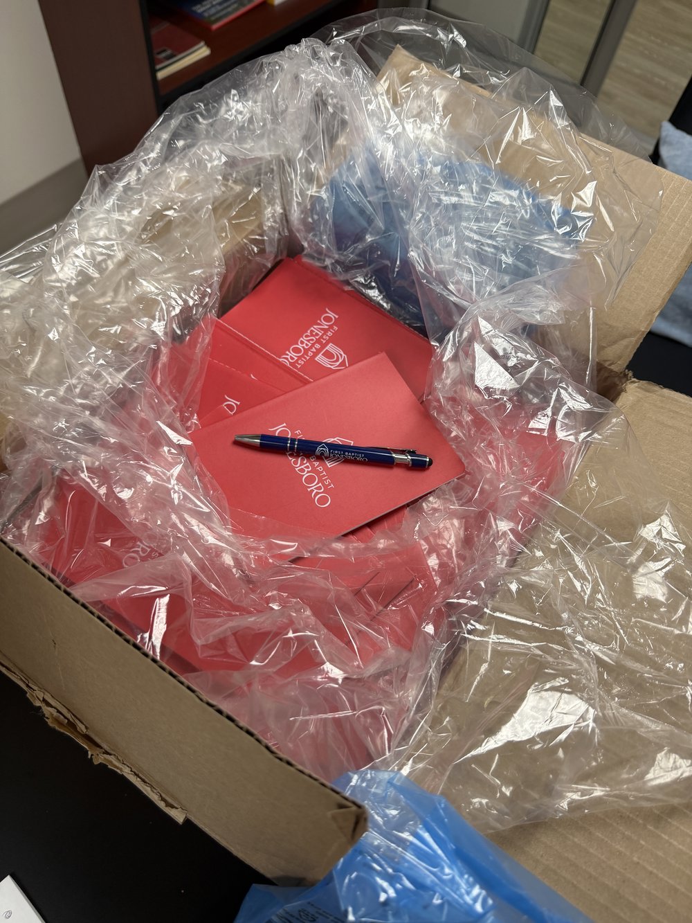 Customer photo from Sharla of our Memo Notebook - 7 inches x 5 inches, a box with red papers and a pen