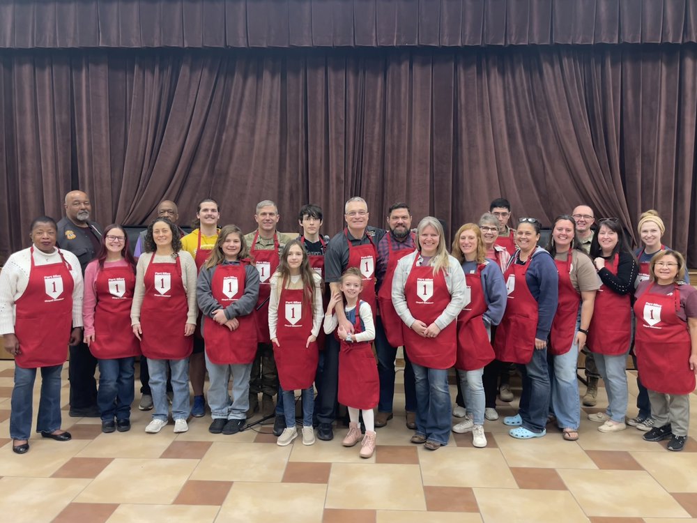 Customer photo from Mike of our Q-Tees Full Length 2 Pocket Apron, a group of people wearing aprons posing for a photo