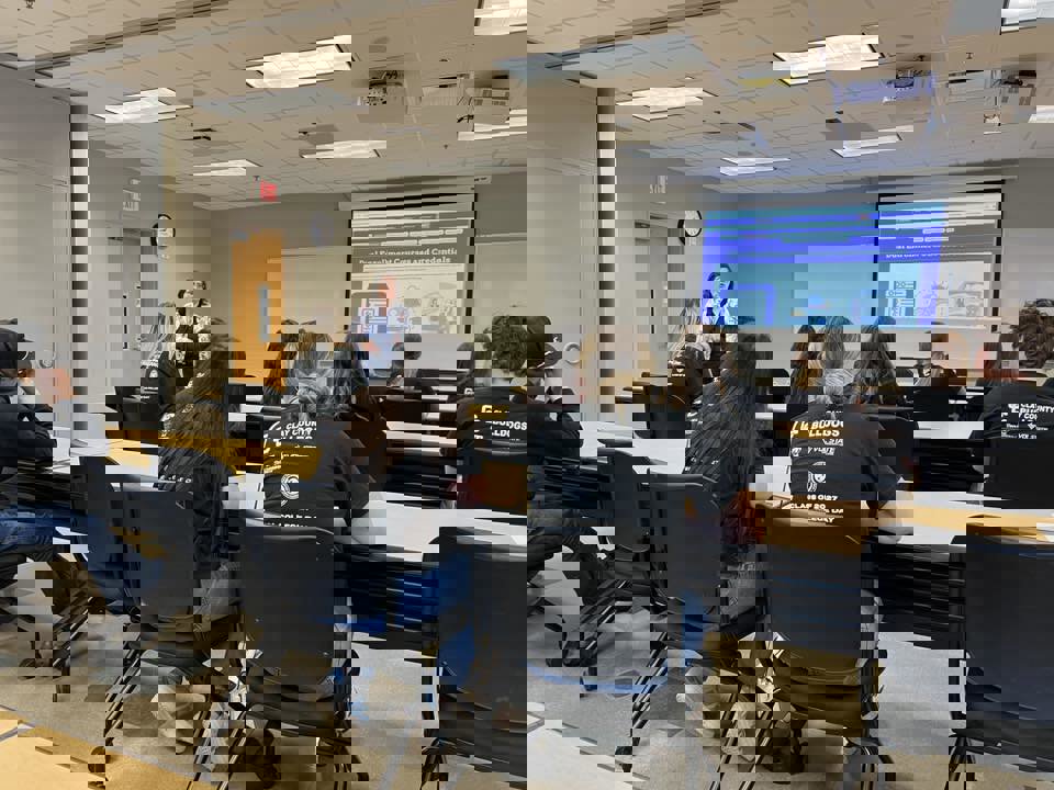 Customer photo from Vanessa of our Port 50/50 Blend T-Shirt - Men's - Screen, a group of people sitting in a classroom