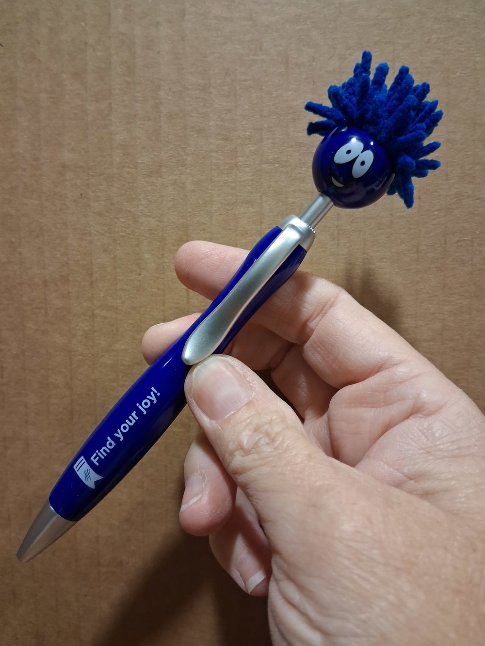 Customer photo from Kristal of our Emoji MopTopper Pen, a hand holding a pen