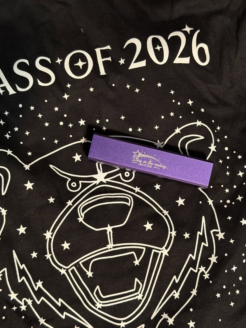 Customer photo from Diane of our Cell Phone Power Bank, a purple rectangular object on a black shirt