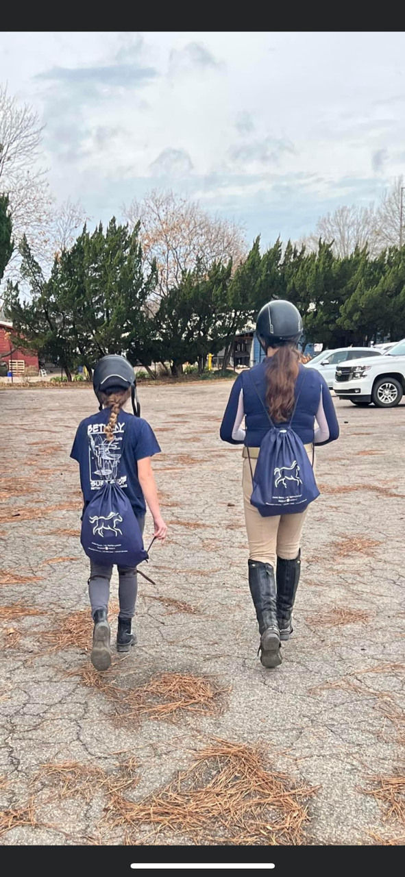 Customer photo from Rose of our Polypropylene Sportpack - 24 hr, two girls wearing helmets and riding helmets walking down a road
