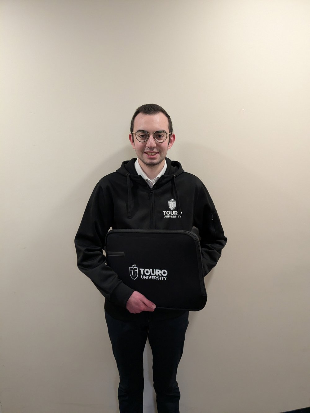 Customer photo from Eli of our Walker Laptop Sleeve - 15 inches - 24 hr, a man holding a black bag