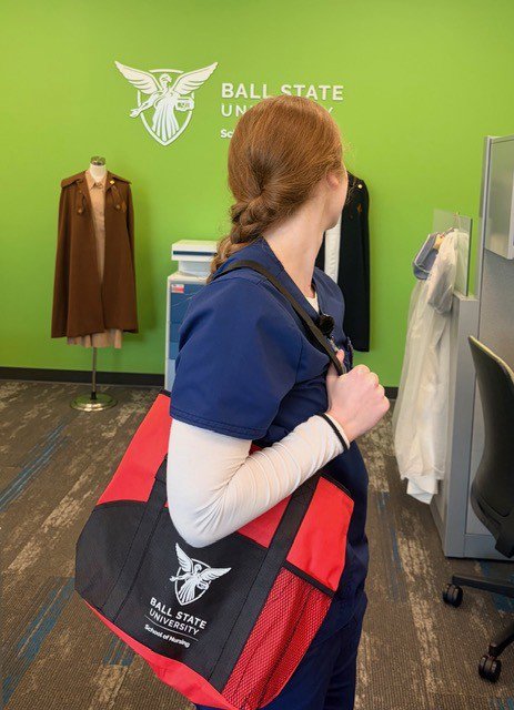Customer photo from Amy of our Backup Business Tote, a woman carrying a red and black bag