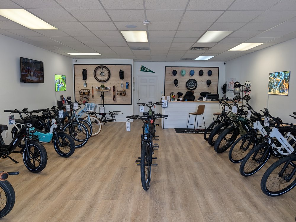 Customer photo from Jerry of our Branded Bills Bare Curved Performance Cap, a room with bicycles and a table