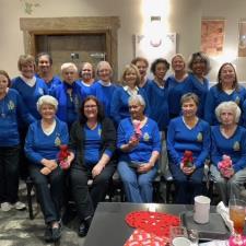 a group of women in blue shirts