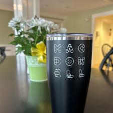 a black tumbler with white text on it
