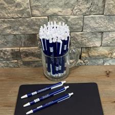 a group of pens on a book