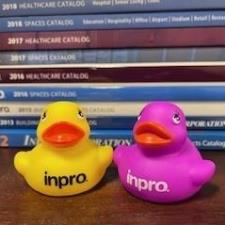 a pair of rubber ducks next to a stack of books