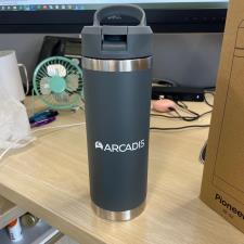 a grey and silver coffee mug on a desk