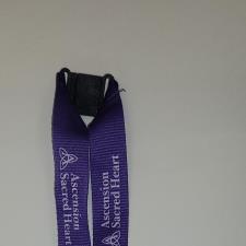 a purple lanyard with white text