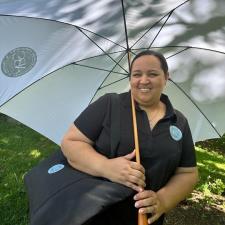 a woman sitting under an umbrella