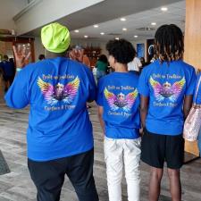 a group of people in blue shirts