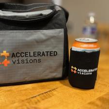 a black and grey bag with a beverage can on a wooden table