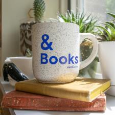 a coffee mug on top of books