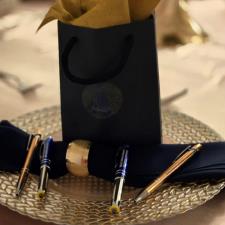 a bag with a napkin and pen on a plate