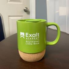 a green mug on a table