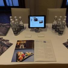 a table with a tablet and a book and water bottles