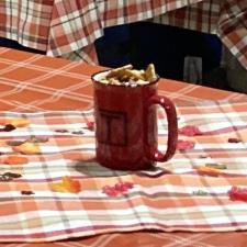 a red mug with food on a table