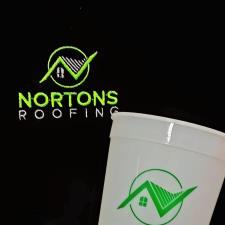 a white cup with green logo