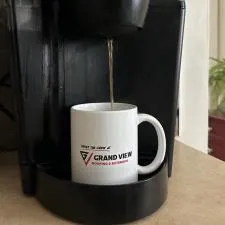 a coffee maker with a coffee cup being poured into it