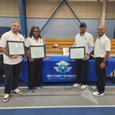 a group of people holding certificates