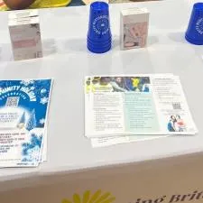 Customer photo from Mona of our Stadium Cup - 16 oz. - Smooth, a table with blue cups and papers