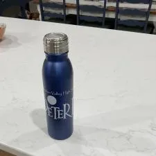 Customer photo from Steven of our Nick Aluminum Bottle - 24 oz., a blue water bottle on a counter