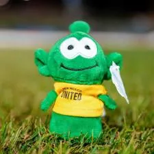 Customer photo from Michael of our Sidekick Shorty - Alien, a green stuffed toy in the grass