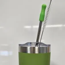 Customer photo from Julie of our Yowie Vacuum Tumbler with Stainless Straw Set - 18 oz. - Powder Coat, a green and silver tumbler with a brush in it