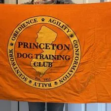 Customer photo from Andrea of our Luxury Beach Towel - Colors - 30" x 60", a person holding an orange flag