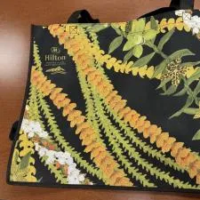 Customer photo from Lora of our Full Color Shopping Tote - 14-3/4" x 19-3/4" - 2 Sided, a black bag with yellow and white flowers on it
