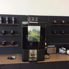 Customer photo from Carl of our Zapata Bistro Ceramic Mug - 14 oz., a coffee machine on a counter