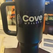 Customer photo from Jeff of our Full Color Sticker - Rectangle - 2" x 4", a black and silver coffee mug