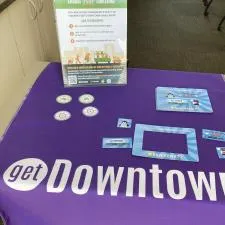 Customer photo from Lilliane of our Serged Table Runner - 28", a purple tablecloth with white text and a purple tablecloth with white text