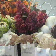 Customer photo from Andrea of our Gloss Eurotote - 5-1/2" x 4-1/2", a group of white bags with flowers