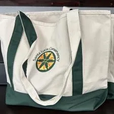 Customer photo from Suzanne of our Two-Tone Accent Gusseted Tote Bag - Embroidered, two white and green bags