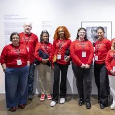 Customer photo from Marianne of our Ultimate Long Sleeve T-Shirt - Men's, a group of people wearing matching red shirts