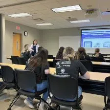 Customer photo from Vanessa of our Port 50/50 Blend T-Shirt - Men's - Screen, a group of people sitting in a classroom